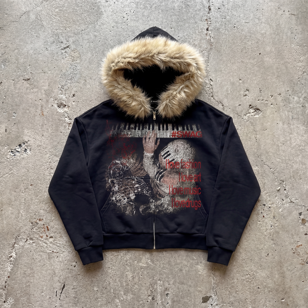 Black hoodie with graphic design and fur-lined hood on a concrete surface