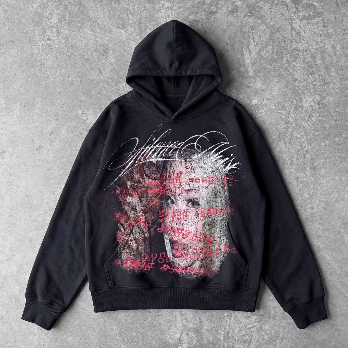 Black hoodie with graphic design on a gray surface